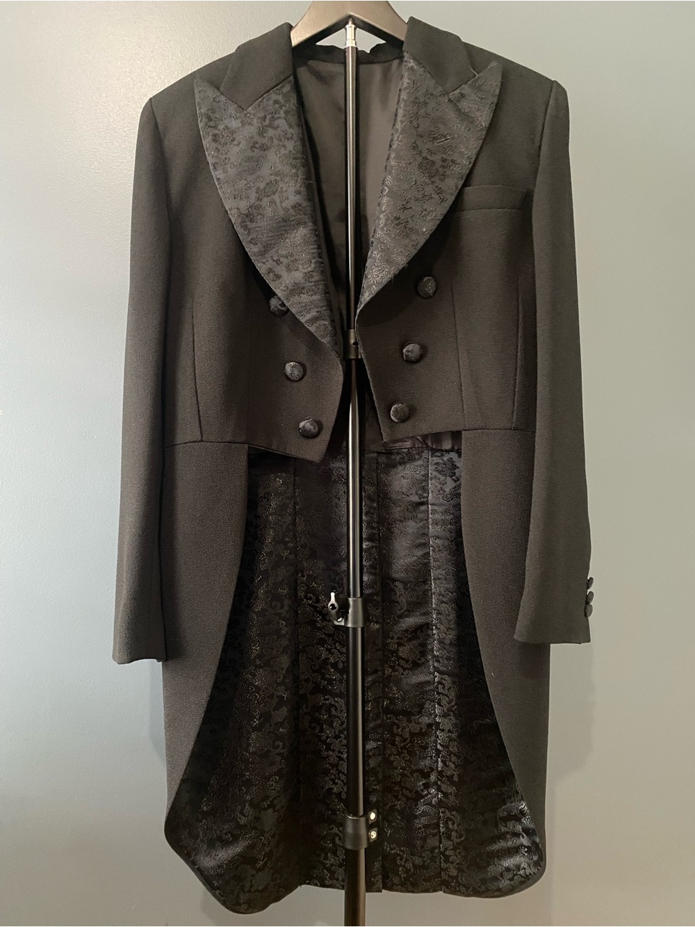 Women's elegant black tuxedo tailcoat with vest and tailored pants with stripe.